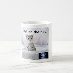 Cat on the bed. coffee mug