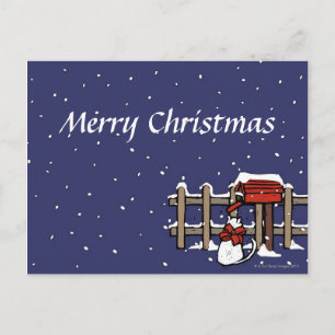 Cat sitting near a mailbox in snowfall holiday postcard