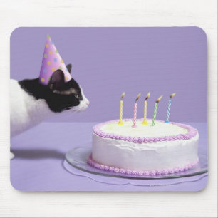 Cat wearing birthday hat blowing out candles mouse pad