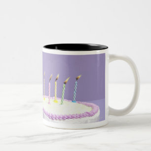 Cat wearing birthday hat blowing out candles on Two-Tone coffee mug