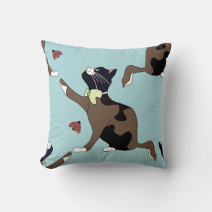 Cat with a bow catches a ladybug. cushion