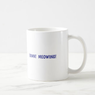 Cat yawns coffee mug