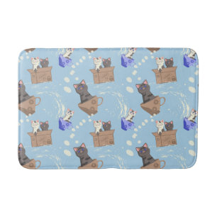 Cats in box and milk drops on blue bath mat
