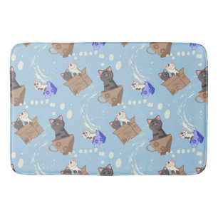 Cats in box and milk drops on blue bath mat