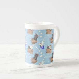 Cats in box and milk drops on blue bone china mug