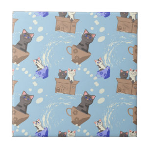 Cats in box and milk drops on blue ceramic tile