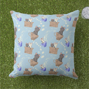 Cats in box and milk drops on blue cushion