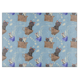 Cats in box and milk drops on blue cutting board