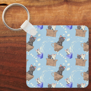 Cats in box and milk drops on blue key ring