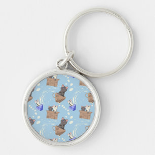 Cats in box and milk drops on blue key ring