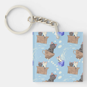 Cats in box and milk drops on blue key ring