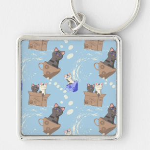 Cats in box and milk drops on blue key ring