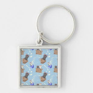 Cats in box and milk drops on blue key ring