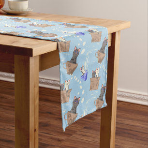 Cats in box and milk drops on blue long table runner
