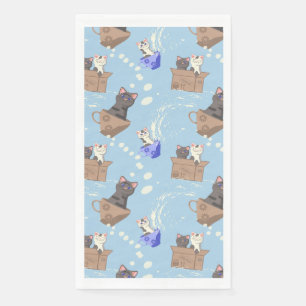 Cats in box and milk drops on blue napkin