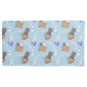 Cats in box and milk drops on blue pillowcase