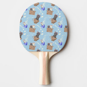 Cats in box and milk drops on blue ping pong paddle