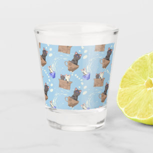Cats in box and milk drops on blue shot glass