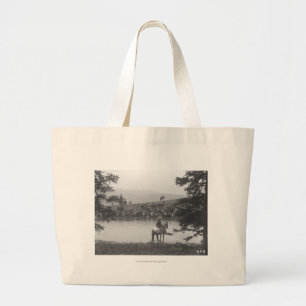 Cattle by a pond with two cowboys. large tote bag