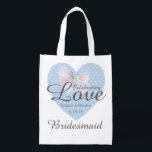 Celebrating Love Romantic Blue Heart Bridesmaid Reusable Grocery Bag<br><div class="desc">Traditional romantic design. A pretty blue heart pattern with a lacy white bow on top. Celebrating Love is written across the heart and bow. Then the bride and groom first names with the date of the wedding. The bridesmaid title is written below. All of the text can be easily changed....</div>