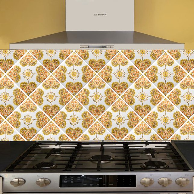 Ceramic Tile with repeating ochre design (gold and orange  geometric tile shown  on a kitchen backsplash installed  diagonally.)