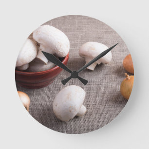 Champignon mushrooms and onions on the table round clock