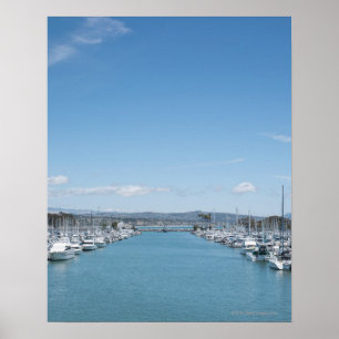 channel in harbor on a sunny day with blue sky poster