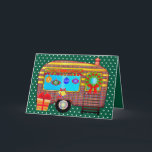 Cheerful and Festive Retro Camper Holiday Card<br><div class="desc">An adorable retro camper trailer Is decorated for the holidays. The festive camper Is adorned with bright cheerful plaid. The door is decorated with a pine wreath and ribbon bow. Vintage holiday ornaments hang in the window. Holly leaves and berries are placed over the window. Sleigh bells with a bow...</div>