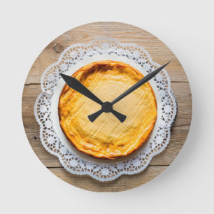 Cheesecake on rustic wood cake top. round clock
