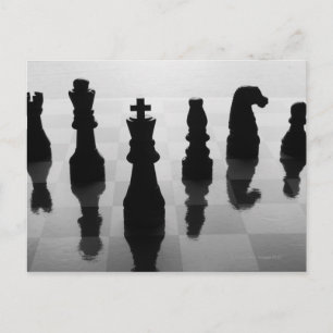 Chess pieces on chess board in black and white postcard