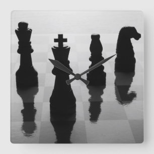Chess pieces on chess board in black and white square wall clock