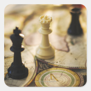 Chess pieces on old world map square sticker