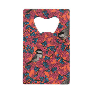 Chickadee birds on blueberry branches on orange