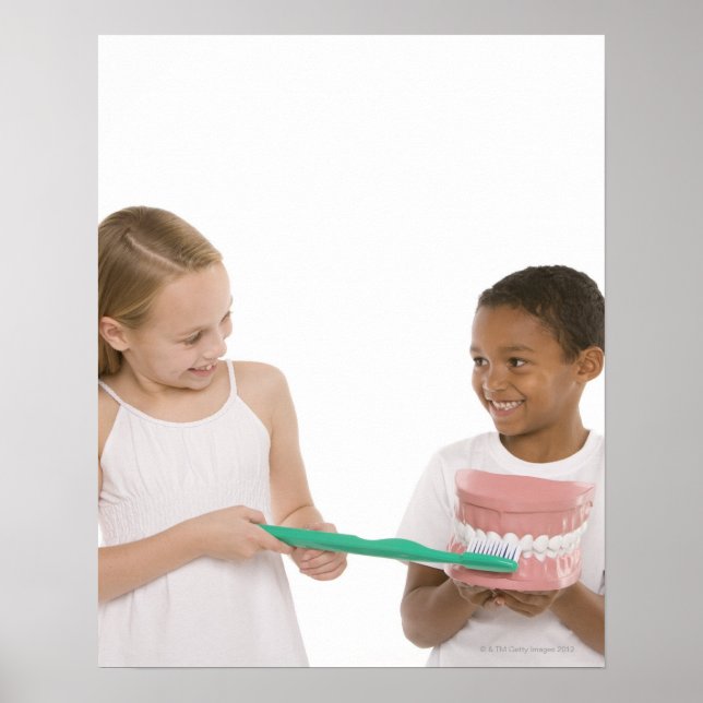 Children with a model set of teeth and oversized poster (Front)