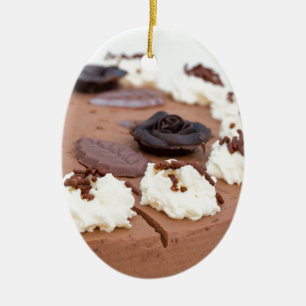 Chocolate cream cake with cake lace in detail ceramic tree decoration