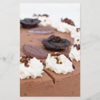 Chocolate cream cake with cake lace in detail stationery