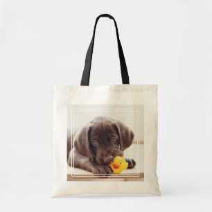 Chocolate Labrador Puppy With Toy Duck Tote Bag