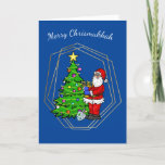 Chrismukkah Santa with Menorah Christmas Card<br><div class="desc">This Chrismukkah card features Santa Claus holding a menorah by a Christmas tree with a star and lights. So, your holiday can be bright from either a Christmas tree or from the candles on the Menorah. Well, that's my idea anyway. But, you're free to change the inside greeting to suit...</div>