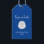 Christmas Beach Sand Dollar Peace on Earth Blue Gift Tags<br><div class="desc">Christmas Beach Peace on Earth Blue Tropical Holiday gift tag,  with a sand dollar and white typography design. With customisable lettering,  you can add your own text. A simple way to add a touch of the ocean to your holiday presents.</div>