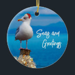 Christmas Beach Seas and Greetings Seagull Ocean Ceramic Ornament<br><div class="desc">This design may be personalised by choosing the Edit Design option. You may also transfer onto other items. Contact me at colorflowcreations@gmail.com or use the chat option at the top of the page if you wish to have this design on another product or need assistance. See more of my designs...</div>