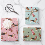 Christmas Beagles Pink Blue Green Wrapping Paper Sheet<br><div class="desc">Cute beagles dressed in festive holiday outfits,  Santa hats and argyle sweaters with scattered Christmas ornaments on a pink,  blue and green background.</div>