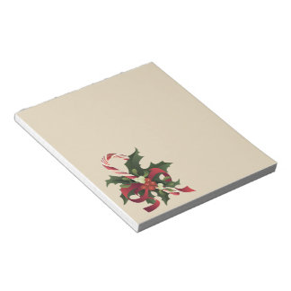 Christmas candy cane in a mistletoe and holly berr notepad