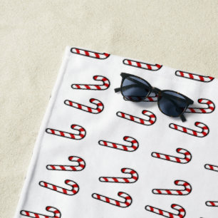 Christmas candy cane on white beach towel