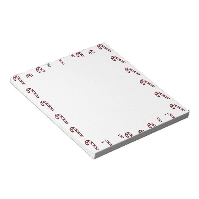Christmas candy cane on white notepad (Angled)