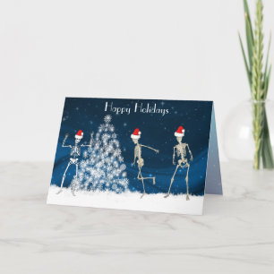Christmas cavorting skeletons on blue holiday card