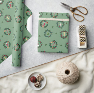 Christmas crowns with embellishments on green. wrapping paper