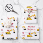 Christmas Excavator Construction Truck Custom Name Wrapping Paper Sheet<br><div class="desc">A cute illustration of a yellow toy excavator wearing a Santa hat and decorated in Christmas lights digging up some Christmas gifts with words "Merry Christmas" and your custom name. Perfect for construction truck lovers of all ages. An ideal Christmas wrapping paper for excavator truck enthusiasts big or small, girls...</div>