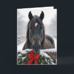Christmas Horse Card<br><div class="desc">A horse stands behind a wooden fence adorned with a festive wreath and red bow,  surrounded by a snowy winter landscape.
Inside text can be changed.</div>