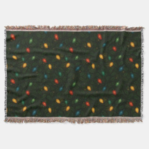Christmas lights wrapped in holly leaves patterned throw blanket