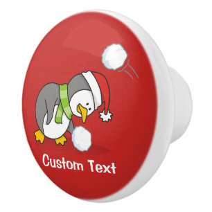 Christmas penguin getting a snow ball ceramic knob